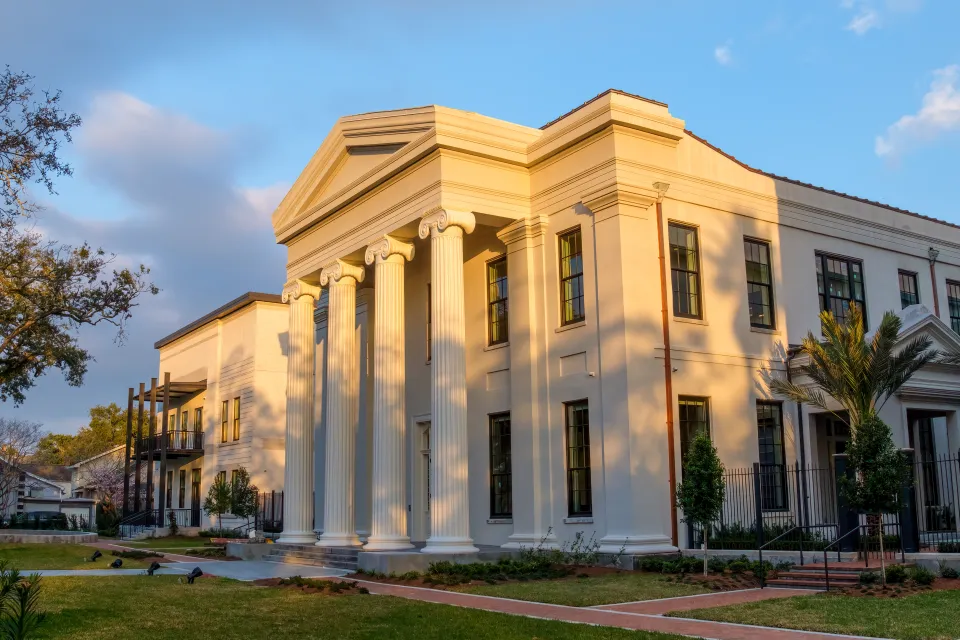 View of renovated Greek Revival Carrollton Courthouse at golden hour with new construction building next to it
